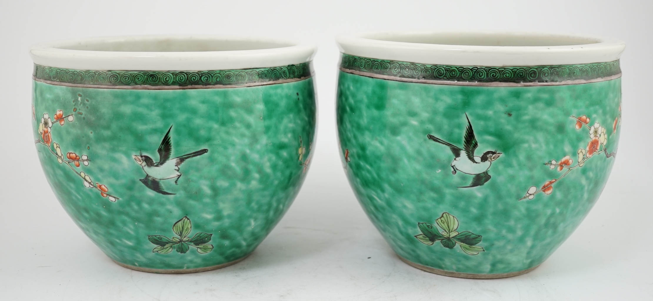 A pair of Chinese famille verte green ground jardinieres, Kangxi marks, but late 19th century